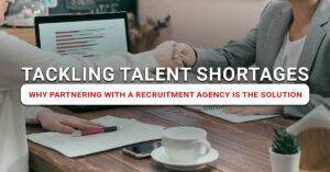 Business professionals sealing recruitment partnership—a solution to talent shortages and strategic hiring support.