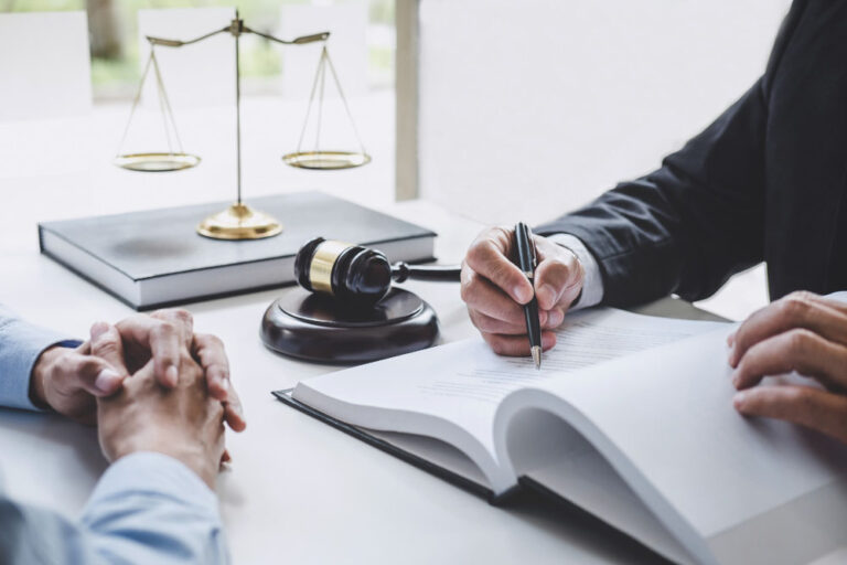 lawyer and a businessman, both male, working together and engaging in a discussion regarding legal compliance